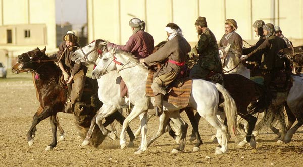 A game of buzkashi in Mazar-e-Sharif, Afghanistan. Sometimes in teams, buzkashi players fight to drag a goat or calf carcass to the goal.