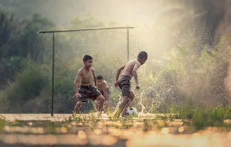 Children playing soccer (football) Children playing soccer (football)