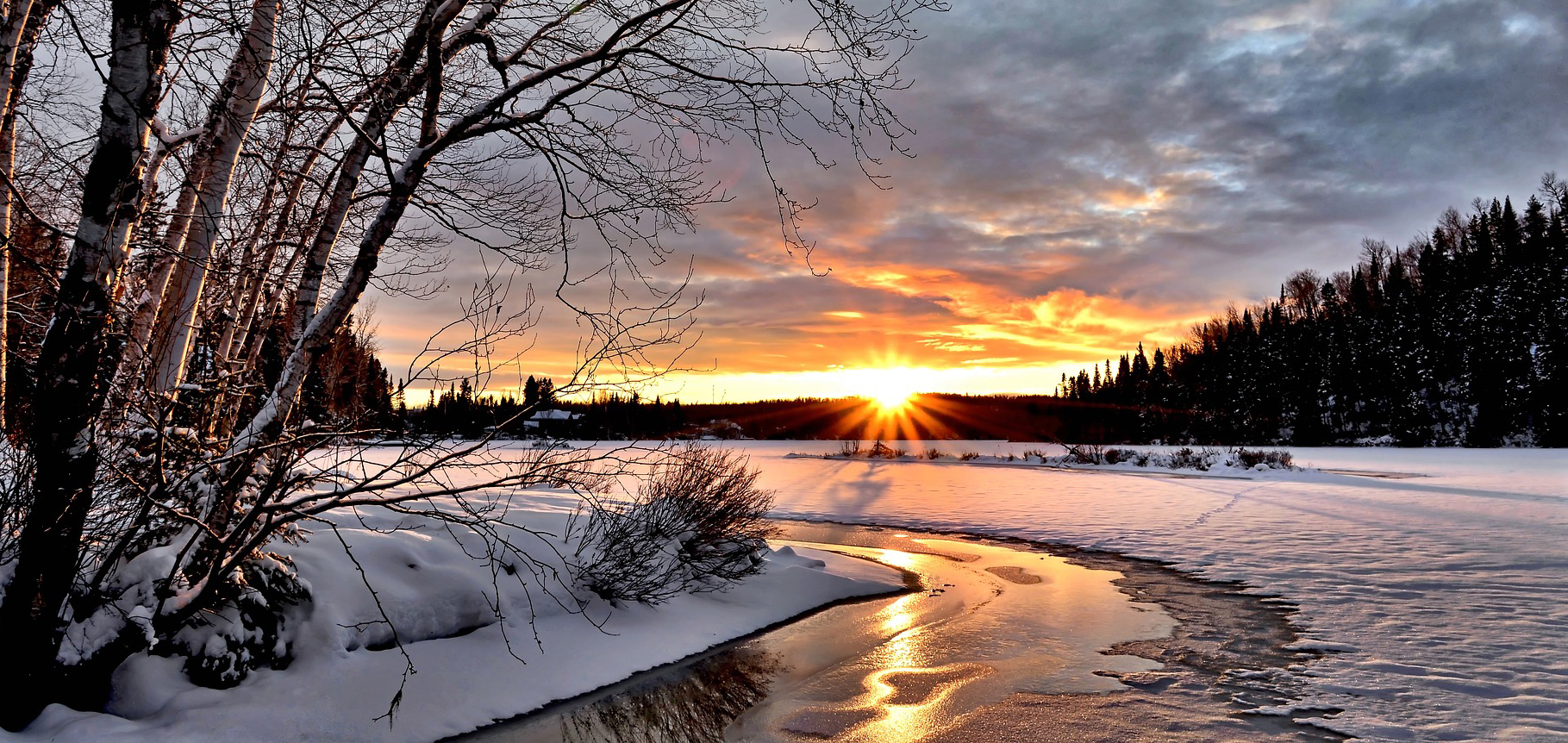 snow, sun, and frozen river