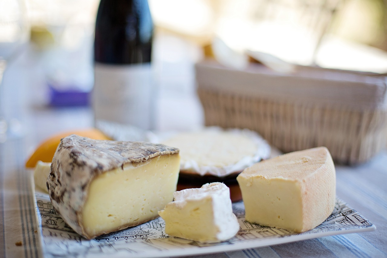 Man is a cheese maker in the process of producing different varieties of  cheese in the industry. Milk cheese making Photos