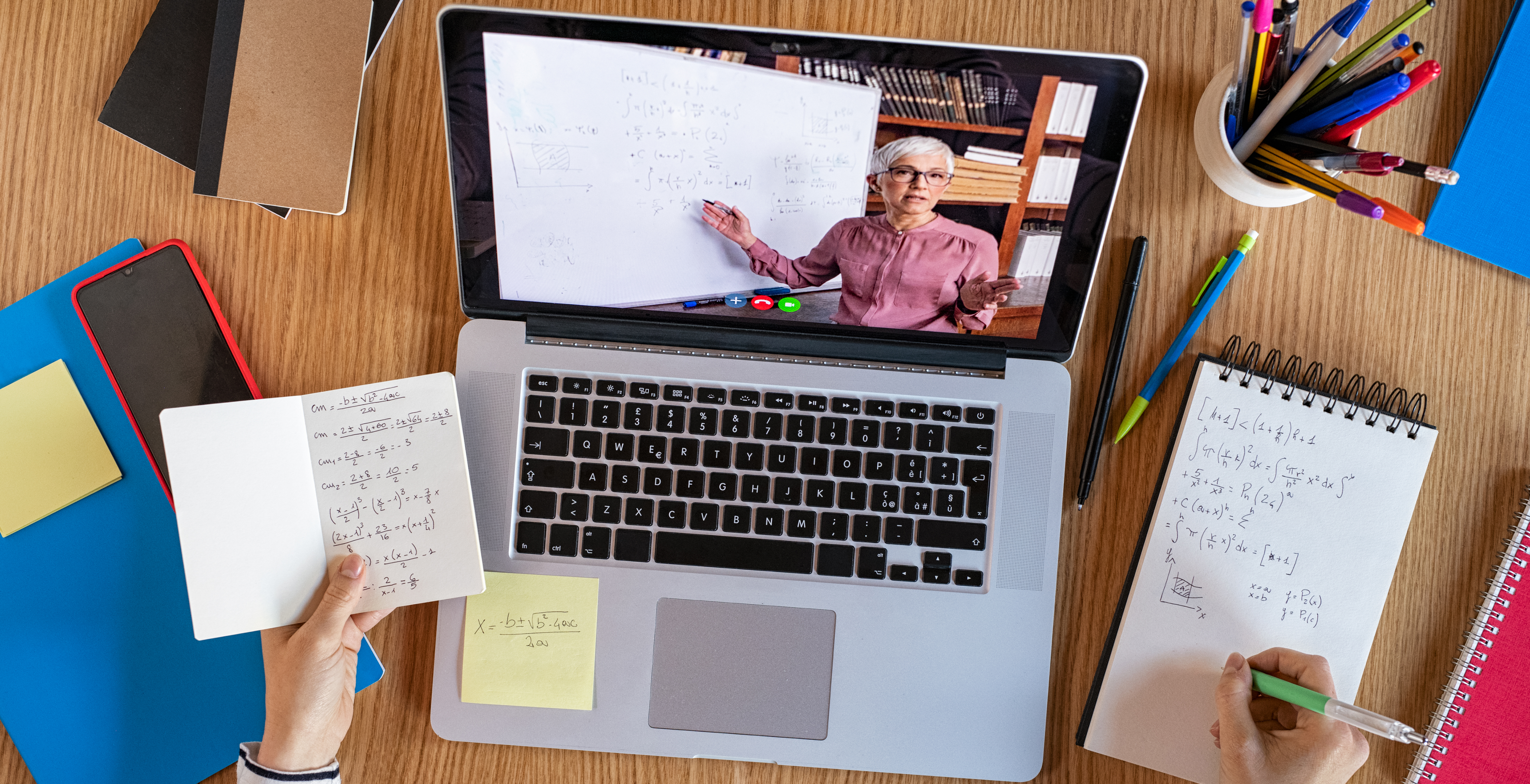 High angle view of video conference with teacher on laptop at home. College student learning maths while watching online webinar, listening audio course. Top view of girl in video call with personal tutor on computer, distance and e-learning education concept.