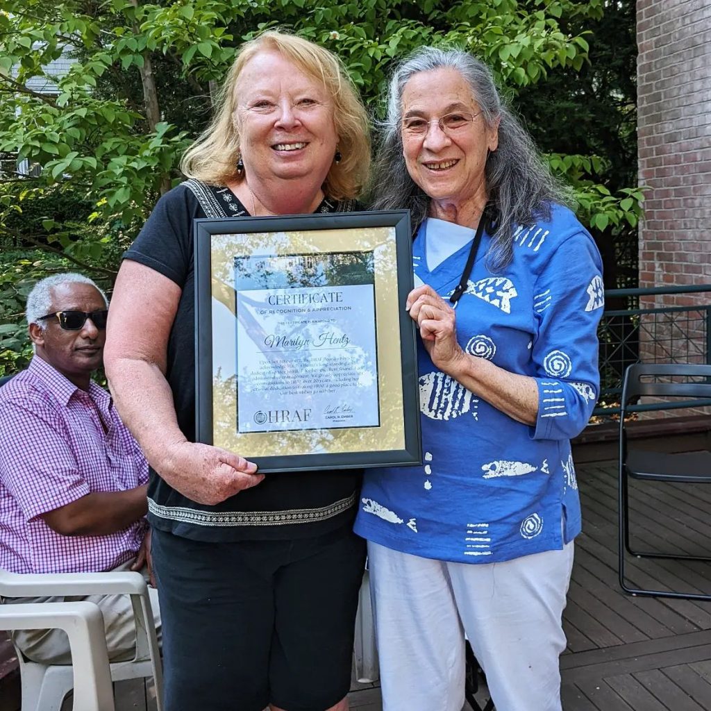 Marilyn Hentz at her retirement with Carol Ember holding certificate or recognition for her service