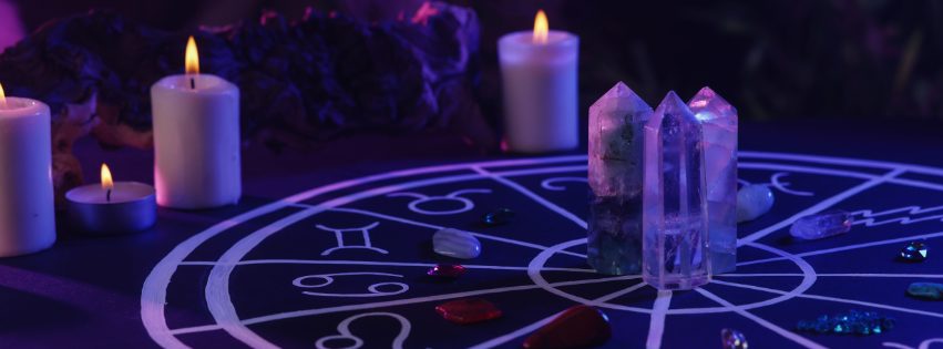 Dark table with crystals and charms